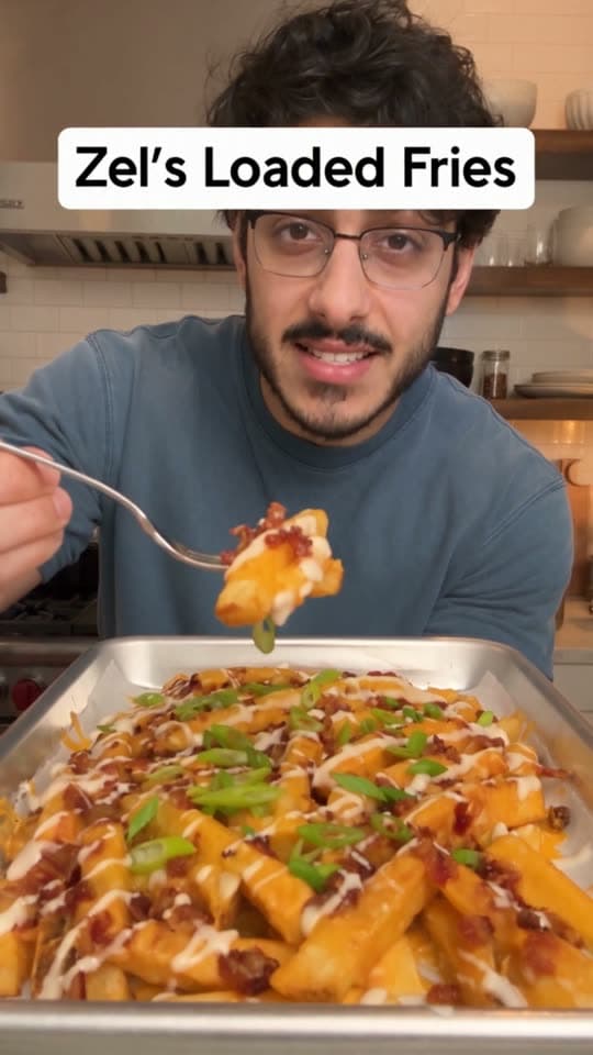 Creator tasting loaded fries from a sheet pan